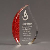 Color cast flame shaped acrylic award with red glitter acrylic cast on left side of flame.